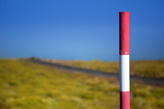 Snow road poles in high mountain blue sky in Canary Islands