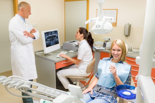 Smiling patient woman sitting at dental chair modern stomatology clinic