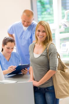 Female patient coming to dental surgery check-up appointment reception