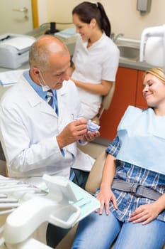 Visit at dentist showing female patient model of teeth