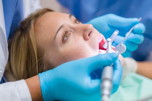 Scared patient at dentist office have teeth checkup dental tools