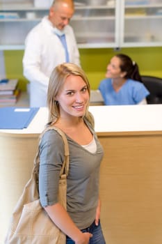Female patient coming to dental surgery check-up appointment reception