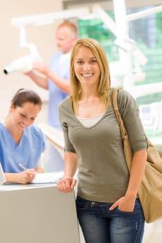 Female patient coming to dental surgery check-up appointment reception
