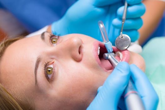 Close-up woman's mouth dental tools have teeth checkup stomatology treatment