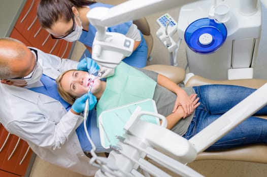 At the dentist young woman patient lying on dental chair