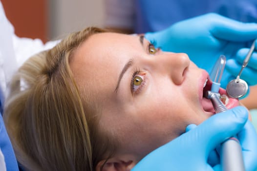Close-up of dental tools inside patient open mouth teeth check-up