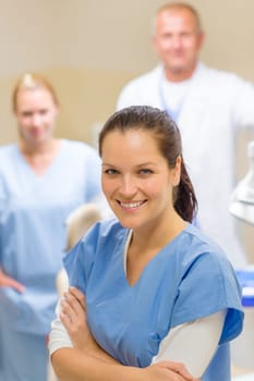 Smiling dental hygienist woman with stomatology team of medical professionals