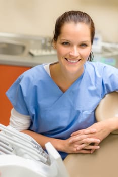 Smiling professional dentist woman sitting at dental surgery office