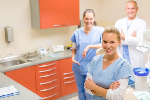 Team of dentist and nurses posing at dental surgery