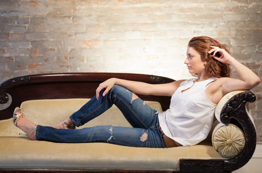 Portrait of a beautiful young woman relaxing on the couch