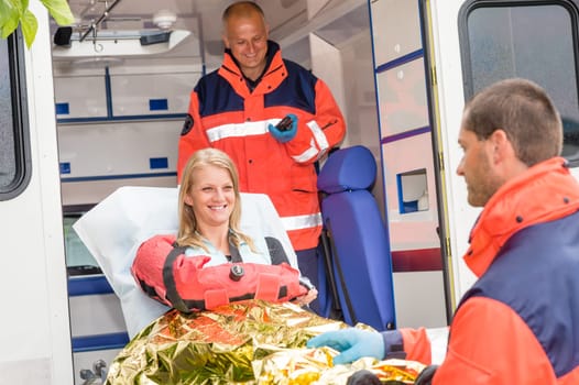Woman with broken arm in ambulance paramedics accident helping victim