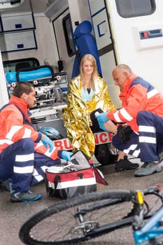 Bike accident woman emergency doctor bandage leg in ambulance