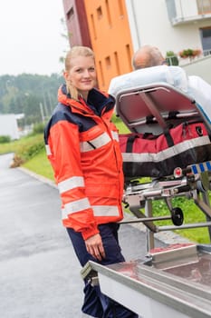 Patient on stretcher with paramedic ambulance aid emergency woman