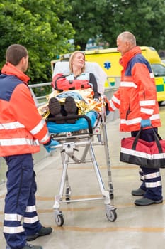 Patient talking with paramedics after accident aid emergency arm injury