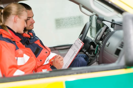 Emergency ambulance car paramedics sitting medical work female doctor
