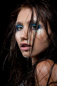 Young woman with creative make-up in mermaid style Wet hair