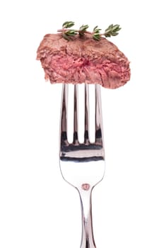 Beef tenderloin with thyme on a fork