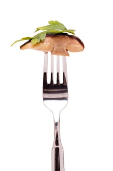 Fried porcini mushroom and parsley on a fork