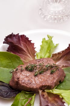 Beef steak with thyme on lettuce
