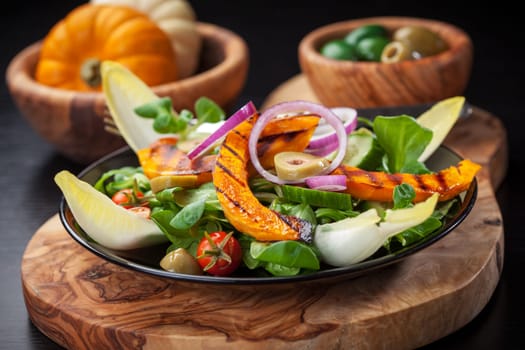 Delicious field salad with grilled pumpkin stripes for Thanksgiving