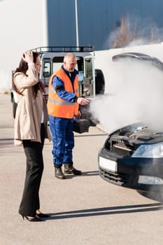 Woman with technician help smoking engine car breakdown trouble accident