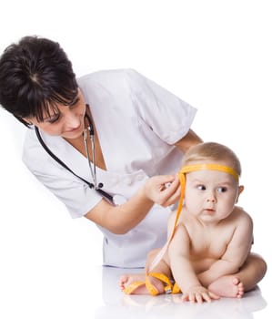 beautiful doctor and baby on a white background. Doctor measures boy with tape