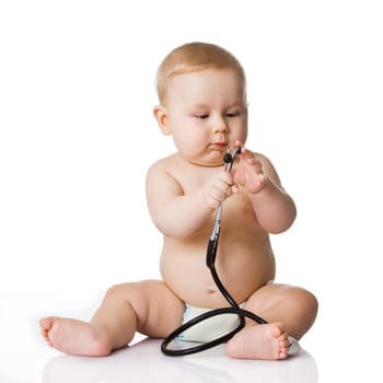 Sweet baby with stethoscope on a white background. Adorable baby boy on white