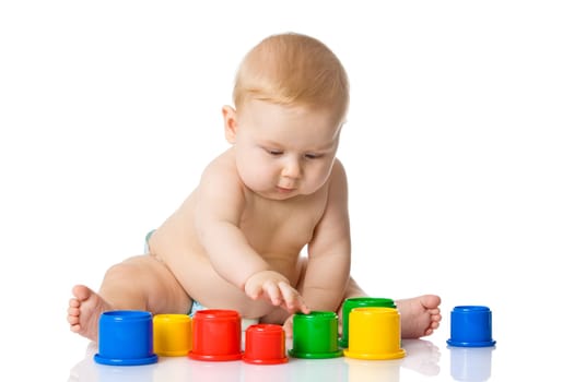 Baby playing with cup toys. Isolated on white background