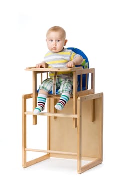 Baby sitting in highchair.