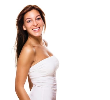 Happy young woman turns around against white background