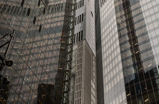 London, UK - Oct 23, 2023 - Glass building with transparent facade of the buildings. View of Highrise office build containing architecture modern designs, Contemporary architectural background, Space for text, Selective focus.