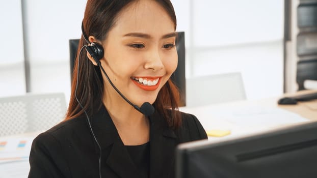 Business people wearing headset working in office to support remote customer or colleague. Call center, telemarketing, customer support agent provide service on telephone video conference call. Jivy