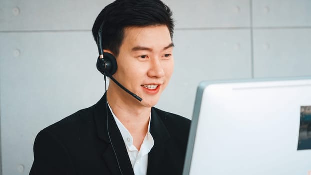 Business people wearing headset working in office to support remote customer or colleague. Call center, telemarketing, customer support agent provide service on telephone video conference call. Jivy