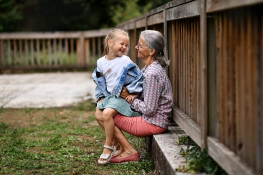 The grandmother and granddaughter playing in the park