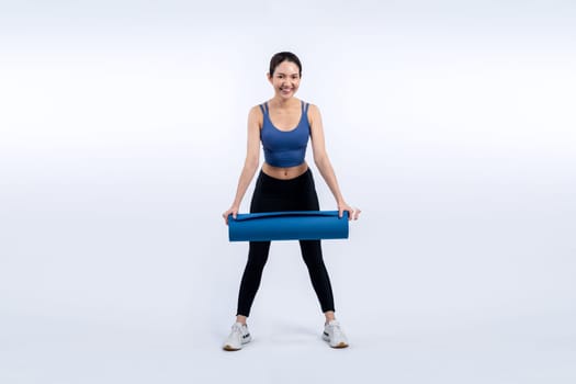 Young attractive asian woman portrait in sportswear with exercising mat. Healthy exercise and workout routine lifestyle concept. Studio shot isolated background. Vigorous