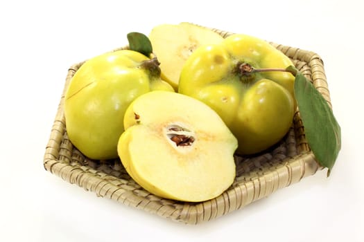 Three quinces against white background