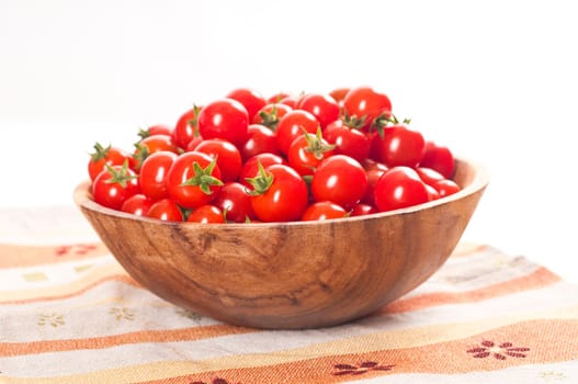 fresh cherry tomatoes in wooden bowl