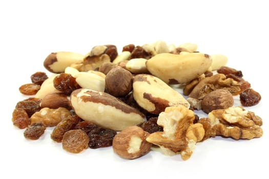 Various nuts and raisins on white background