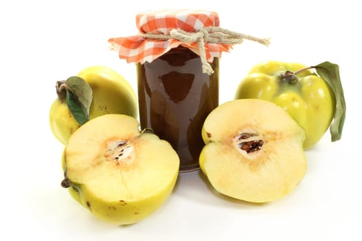 a jar of quince jelly with quince fruits