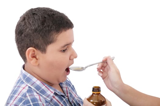 Child taking cough medicine because of the flu