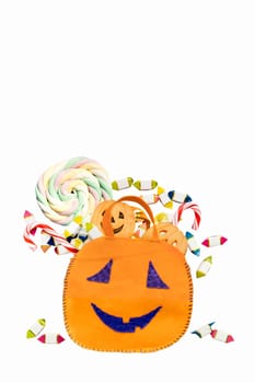 Halloween bucket full of candies and sweets isolated on white. Large space for copy. Clipping path included.