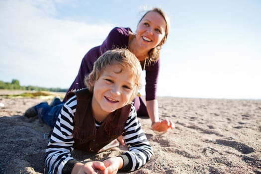 Mother and son relaxing and spending time together on the beach.