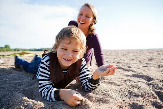 Mother and son relaxing and spending time together on the beach.