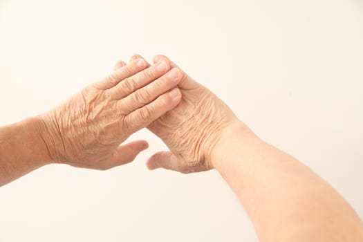 two hands belonging to a senior man