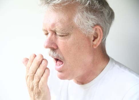 senior man about to sneeze