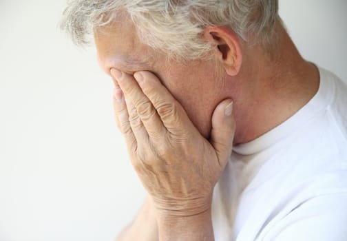 older man overcome with depression or emotions