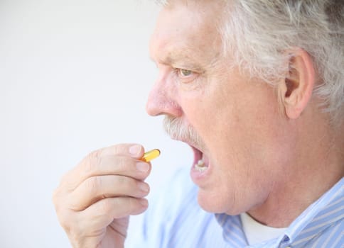 senior takes fish oil supplement