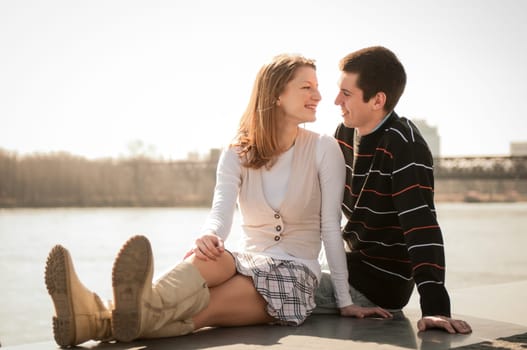 Young happy couple looking on each other  - outdoor lifestyle portrait