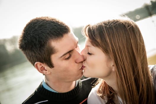 Young happy couple looking on each other - outdoor lifestyle portrait