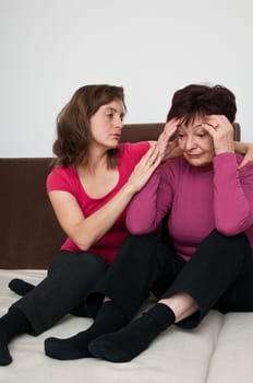 Daughter (young woman) regrets her worried senior mother at home